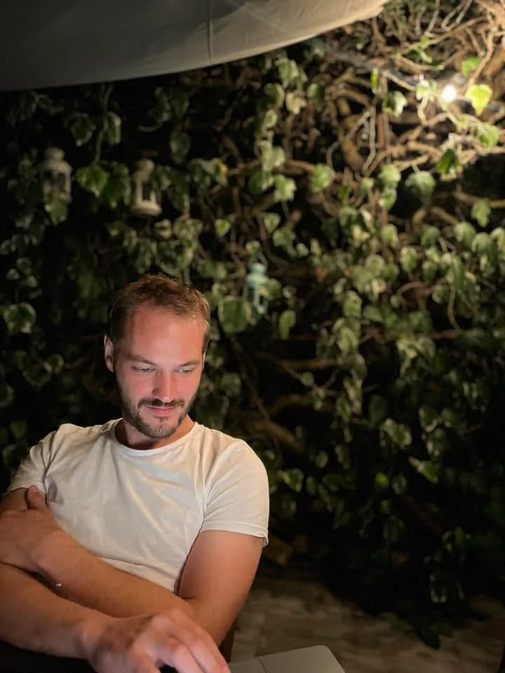 Ivan Lučin working on a laptop outdoors at night